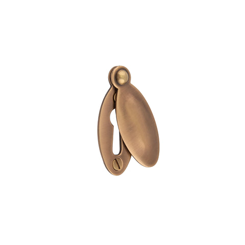 Raised Oval Covered Lever Key Escutcheon - Shown in Very Light Aged